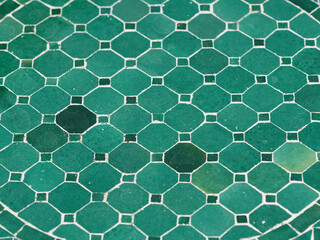 Table pattern consists of octagonal green tiles surrounded by smaller square tiles in a grid...