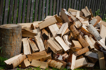 chopped firewood lies in a heap. Preparing for the cold