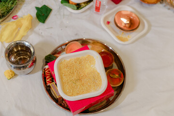 Indian Pooja thali elements: rice, sindoor, and diya, for religious rituals. Selective focus....