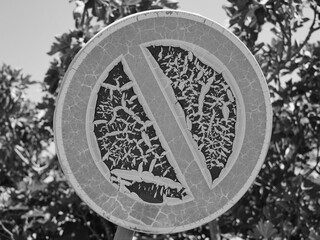 Old no parking sign weathered by the sun, paint peeling off, black and white photo, beautiful...