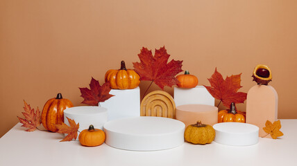 Empty podiums autumn composition for product presentation on brown background, banner size. Autumn decorated background for cosmetic, product branding and design.