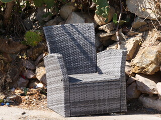 Old chair that has been left somewhere and is used by passers-by as a place to sit.