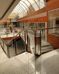 front door foyer entrance to an interior of a home with hardwood flooring beamed ceiling glass wall...