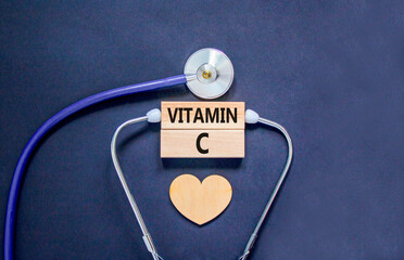 Vitamin C symbol. Concept words Vitamin C on beautiful wooden blocks. Wooden heart and stethoscope....