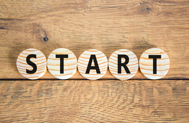 Fototapeta premium Start symbol. Concept word Start on beautiful wooden circles. Beautiful wooden table wooden background. Business lifestyle start concept. Copy space.