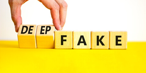 Deepfake or fake symbol. Concept words Fake Deepfake on wooden cubes. Beautiful yellow table white...