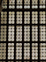 Symmetrical grid of illuminated glass blocks forming a geometric architectural design, modern...