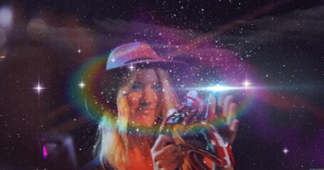 Female musician clapping tambourine activating cosmic overlay and singing into mic energizing music - Powered by Adobe