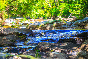 Landscape still shot of the Dure River in Brousse and Villaret in the South of France. Small waterfalls and undergrowth in Occitanie.

