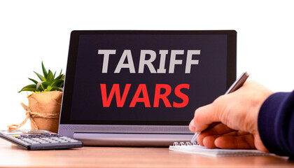 Trade tariff wars symbol. Concept word Tariff wars on beautiful black tablet. Businessman's hand,...