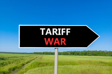 Trade tariff war symbol. Concept word Tariff war on beautiful black road sign. Beautiful green grass field blue sky background. Business trade tariff wars concept. Copy space.