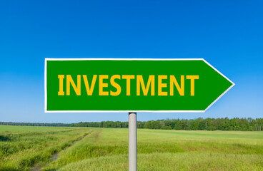 Investment symbol. Concept word Investment on beautiful green road sign. Beautiful blue sky green...
