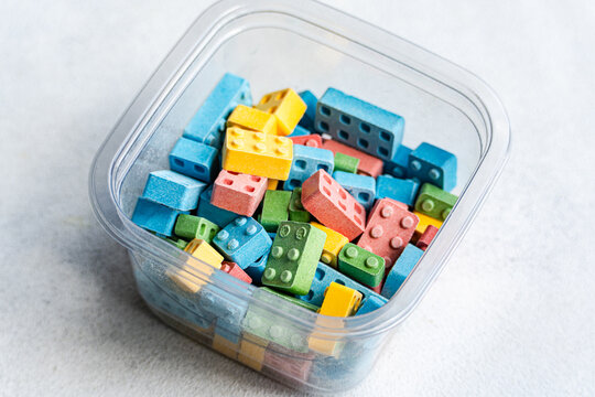 Sweet block candies in vibrant colors in container