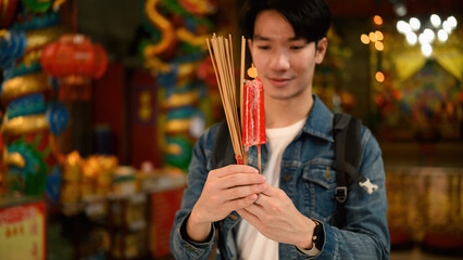 A selective focus image on traveler's hands ready to make a wish or prayer in peacefully shrine