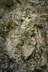 Brown stone on cave wall surface with cracked texture for abstract background and texture. Template for design, natural patterns, space for work, banner,seamless wallpaper, close up. Vertical.