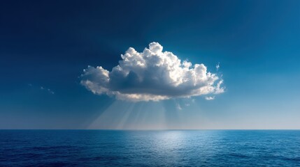 Majestic cumulus cloud illuminates the ocean with radiant sunbeams on a clear day