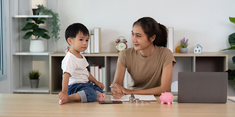 Fototapeta premium Financial Planning: Child and Parent Discussing Savings Strategy with Piggy Bank