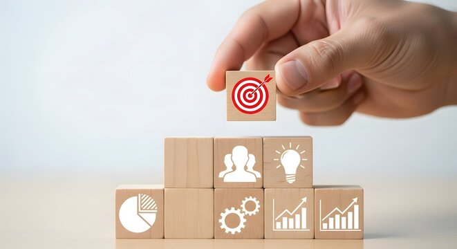 Business strategy concept placing target block on top of wooden blocks success achievement
