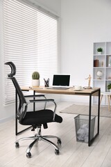 Stylish workplace with modern laptop on wooden desk