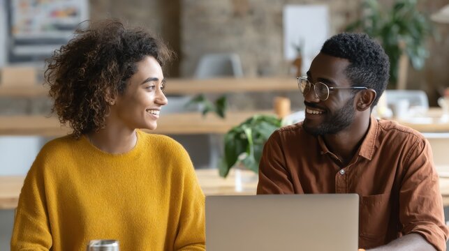 young smiling african american mentor explaining to serious indian coworker project strategy diverse startup coworkers students girl and guy talking discussing working in modern office using laptop n - Powered by Adobe