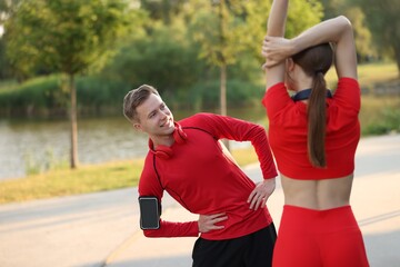 Fototapeta premium Happy couple doing morning exercise outdoors. Healthy lifestyle