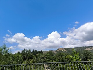 Clouds trees fence