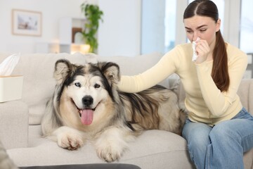 Woman suffering from allergy with her dog at home