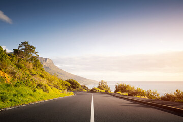 Scenic Road at Sunset with mountain and ocean in Cape Town