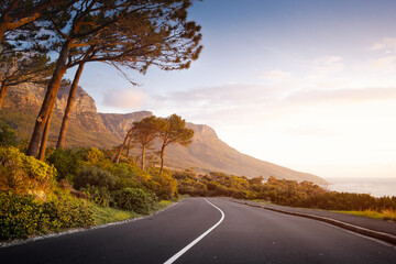 Scenic Road at Sunset with mountain and ocean in Cape Town