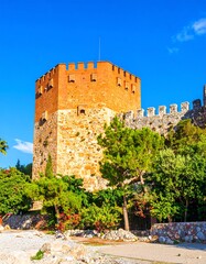 Ancient stone tower, surrounded by trees and landscape