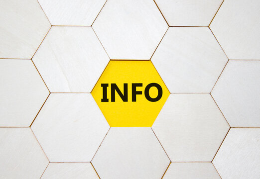 Info symbol. Concept word Info on wooden comb puzzle. Beautiful yellow background. Business and Info concept. Copy space.