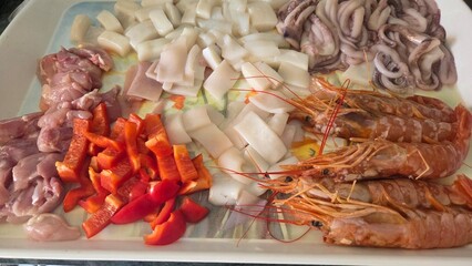 Ingredients for authentic spanish paella featuring seafood and vegetables. Typical cuisine of...