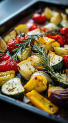Roasted vegetables with herbs and olive oil on baking tray, healthy cooking style