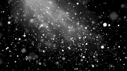 Glowing white particles floating against a dark background with light rays abstract bokeh