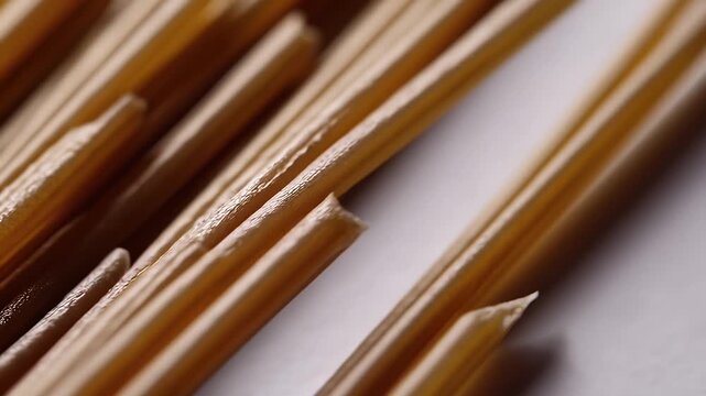 Incredible 4K UHD macro video revealing the finely textured surface and perfectly cylindrical shape of raw spaghetti noodles arranged in neat rows transforming a simple culinary ingredient into a