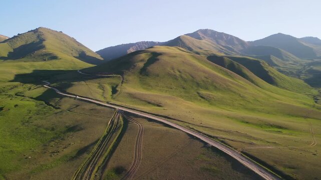 Aerial view of Kalmak-Ashuu Pass, standing at 3,447 meters above sea level. The winding dirt roads runs through mountains and leads to the northern shore of Lake Song-K&ouml;l.
