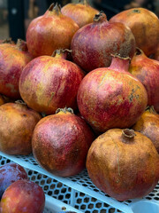 Ripe Pomegranates in Blue Crate