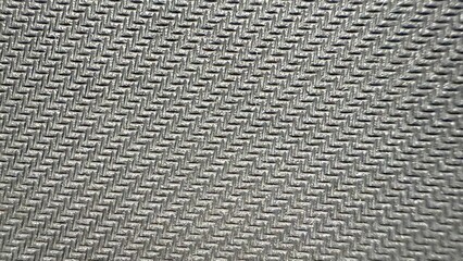 closeup of silver metallic zigzag textured surface with herringbone pattern for industrial or...