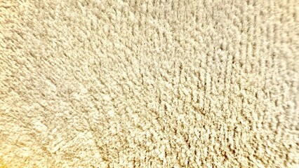 soft cream shaggy fleece texture closeup with warm lighting for cozy textile design and winter...