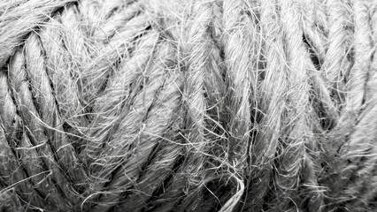 closeup of coarse natural rope texture with frayed hemp fibers for rustic packaging or craft...