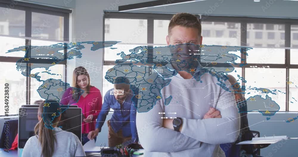 Poster manager standing arms crossed as team reviewing monitor starting it map overlay showing nodes links