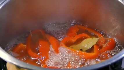 Red pepper is cooked in a saucepan. - Powered by Adobe