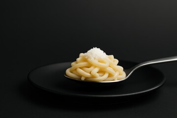 Sodium caution minimalism featuring pasta on a sleek black plate