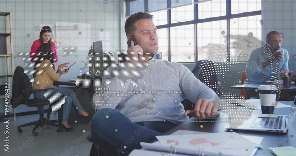 Poster mid-adult man answering smartphone call and world map overlay pulsing data while team using tablet