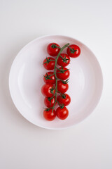 Fresh red tomatoes on white background or light table. Concept farm vegetables and varieties. Space for text