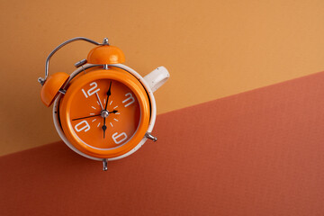 Coffee and clock on a colored background.  Time to drink coffee. Break time. Creative idea.
