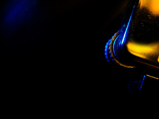 abstract background and texture, close-up of a metallic object with a reflective surface, illuminated by dramatic blue and gold lighting