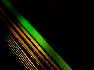 A close-up image of a razor blade, featuring multiple parallel lines illuminated by vivid blue and...