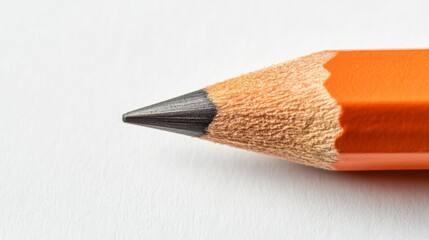 A pencil with a black tip is shown on a white background. The pencil is sharpened and has a pointy tip