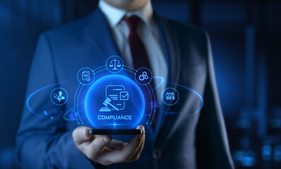 Businessman holding smartphone with compliance icons on screen - business and regulations concept